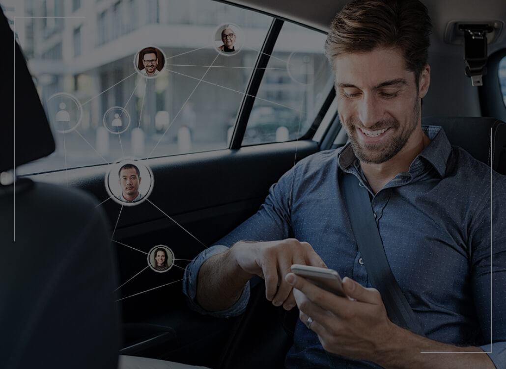 A man, as a passenger in a car, sits and looks at his phone. A man, as a passenger in a car, sits and looks at his phone.